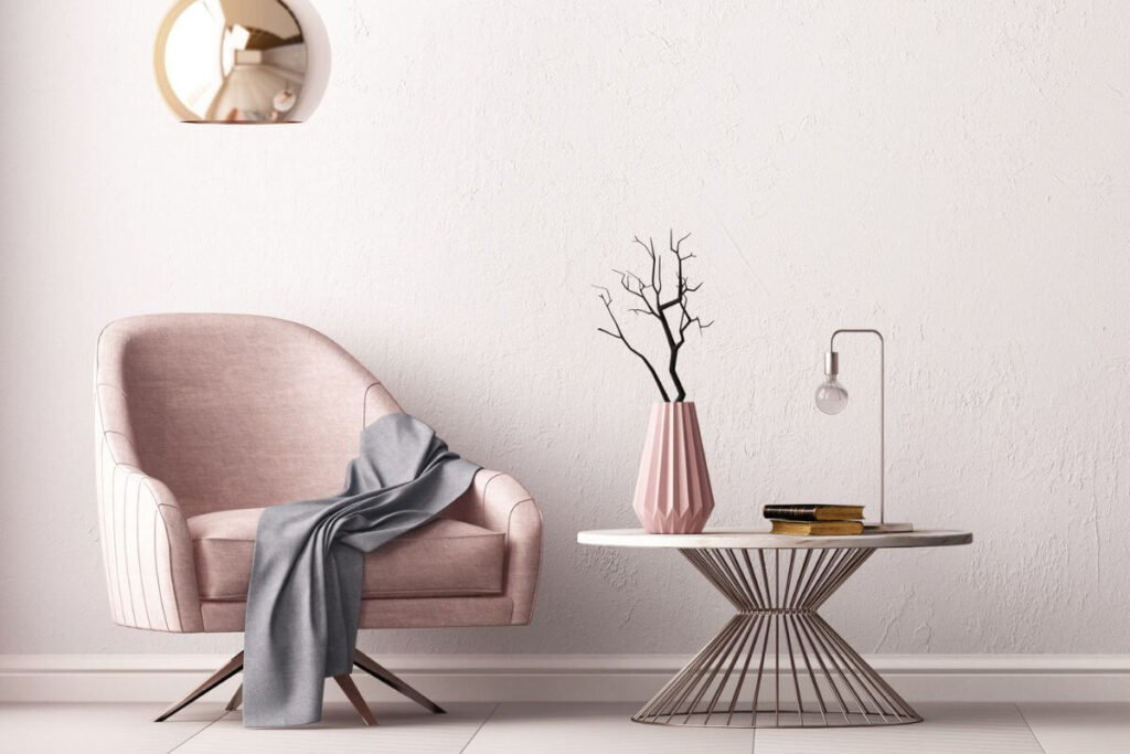 a minimalist chair and table display in shades of pink and gray