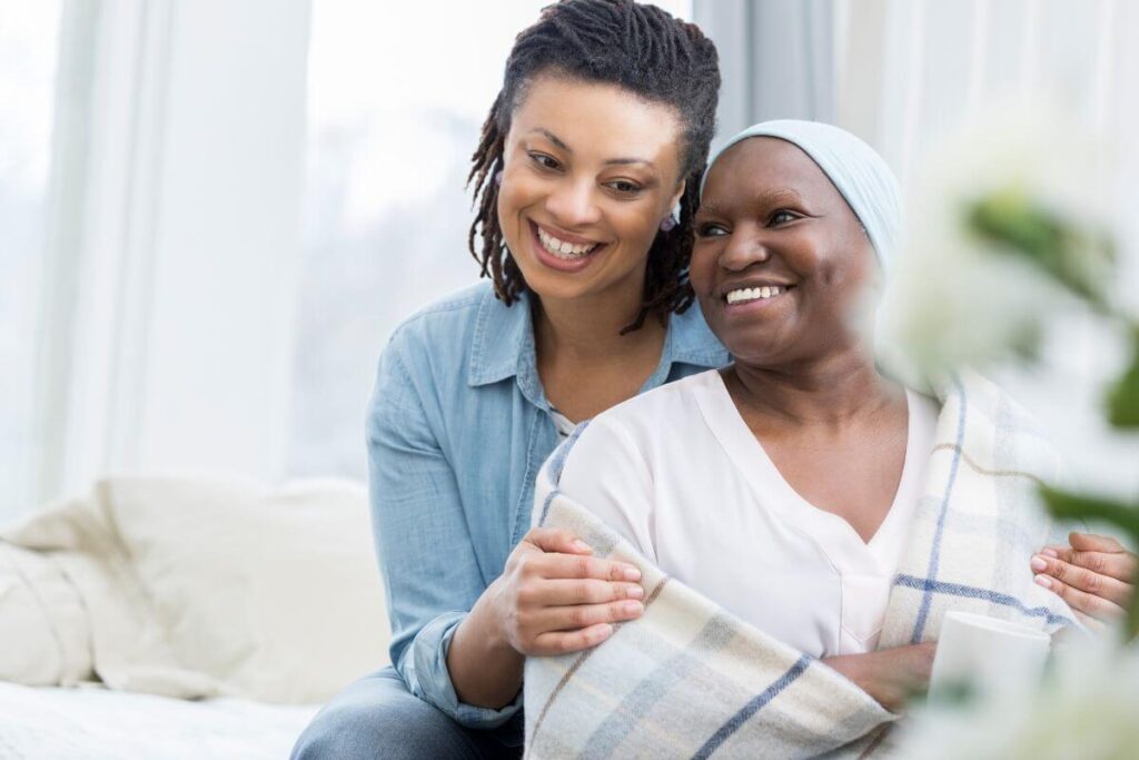 an adult woman and her aging mother smile after enjoying time together talking about family history