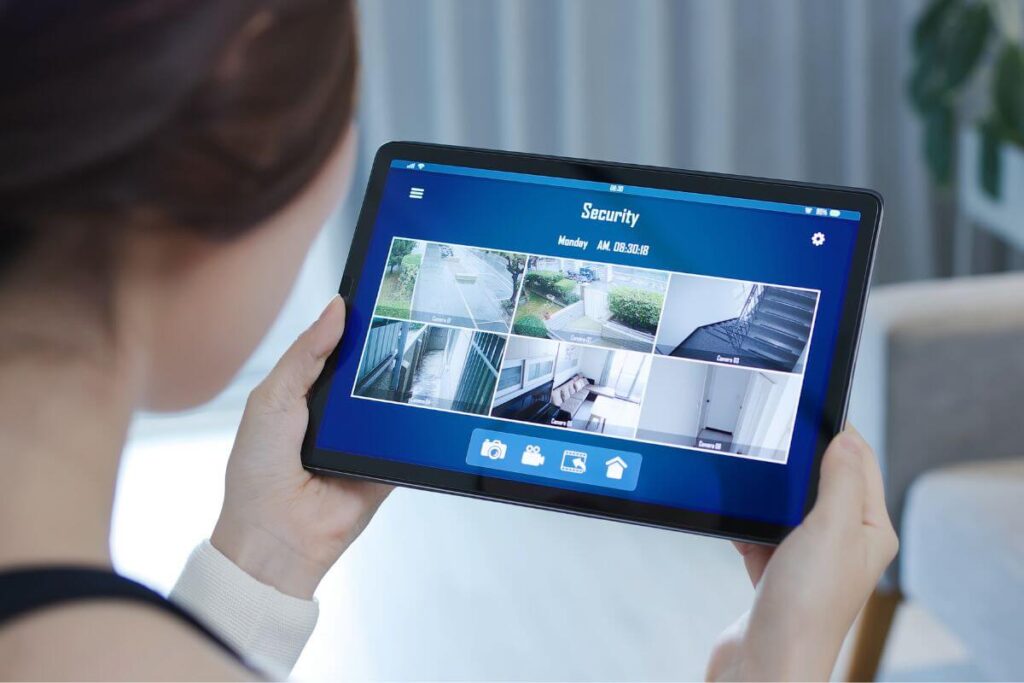 woman looking at her security system views on an ipad