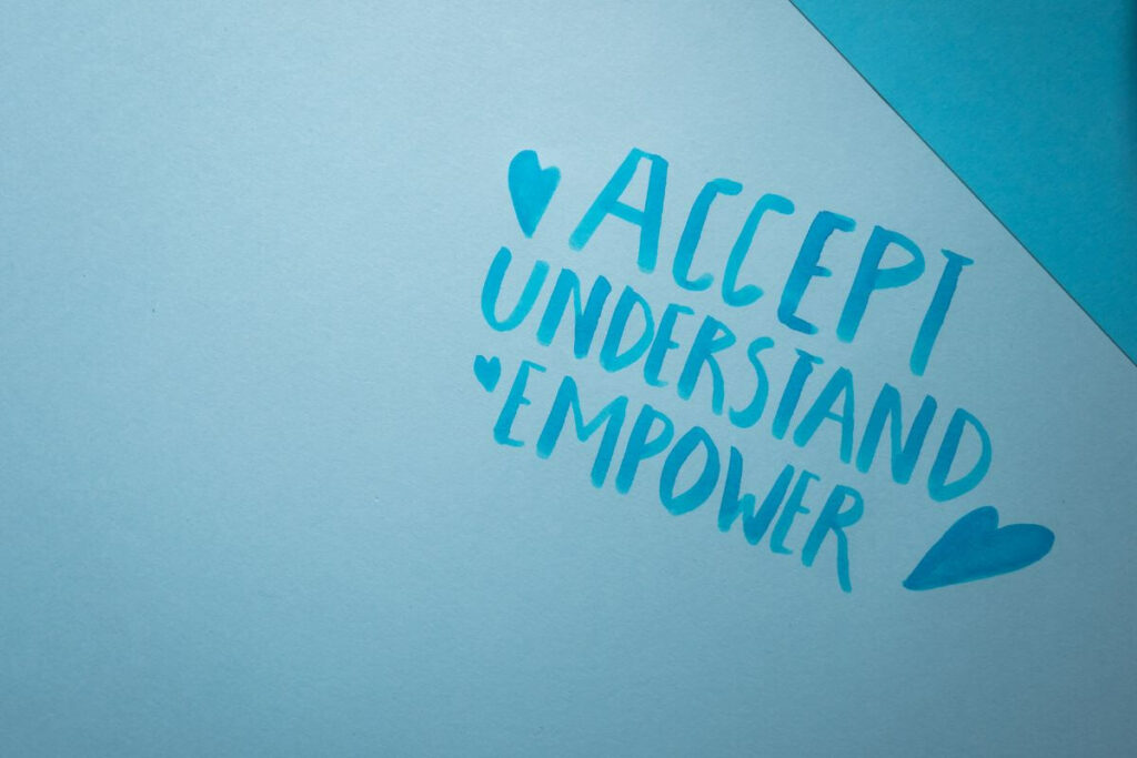 teal colored paper with power words accept understand and empower written on it