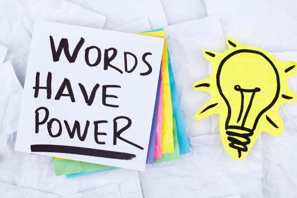 Word have power written on a pile of sticky notes and a light bulb cut-out