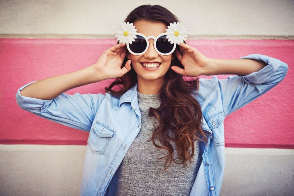 women have fun with big sunglasses and flowers on her head