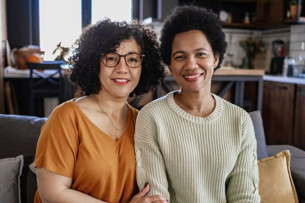 two happy middle aged women dressed casually smile at the camera