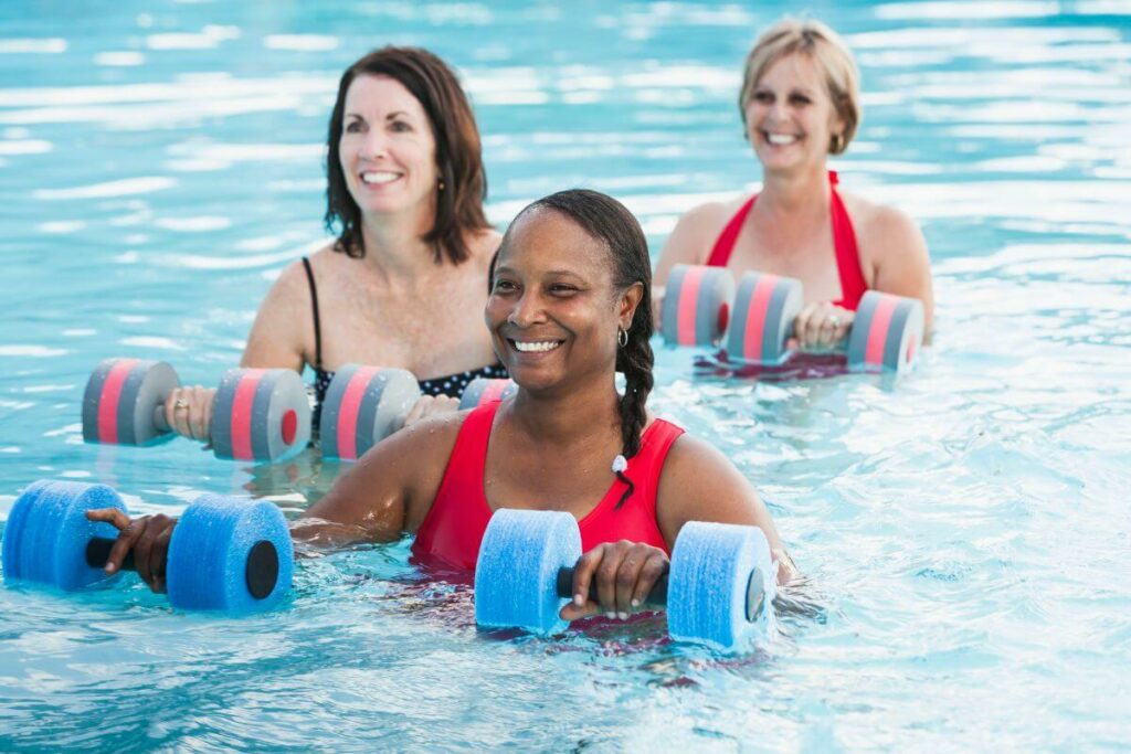 three women in a pool understand the benefits of swimming for seniors