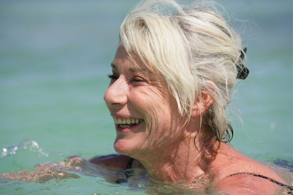 close up of senior women swimming in a pretty blue body of water