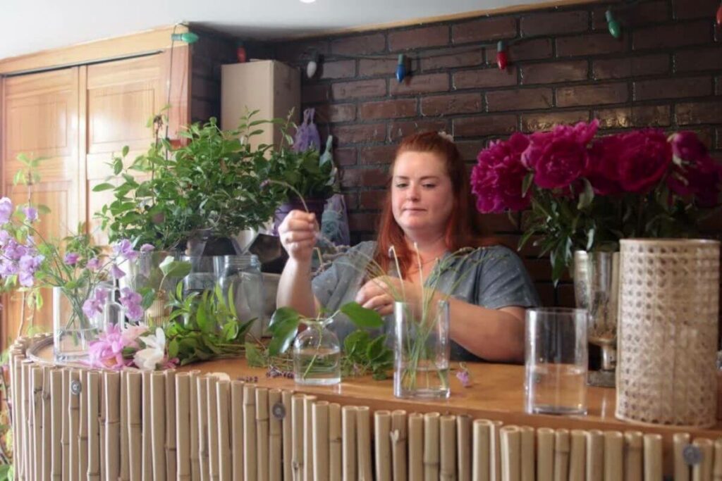 beautiful middled aged woman works with flowers in a florist