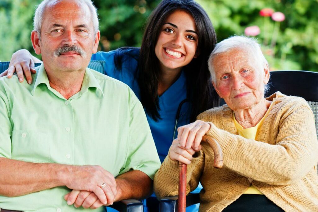 adult child poses between her aging parents after having a difficult conversation about their care