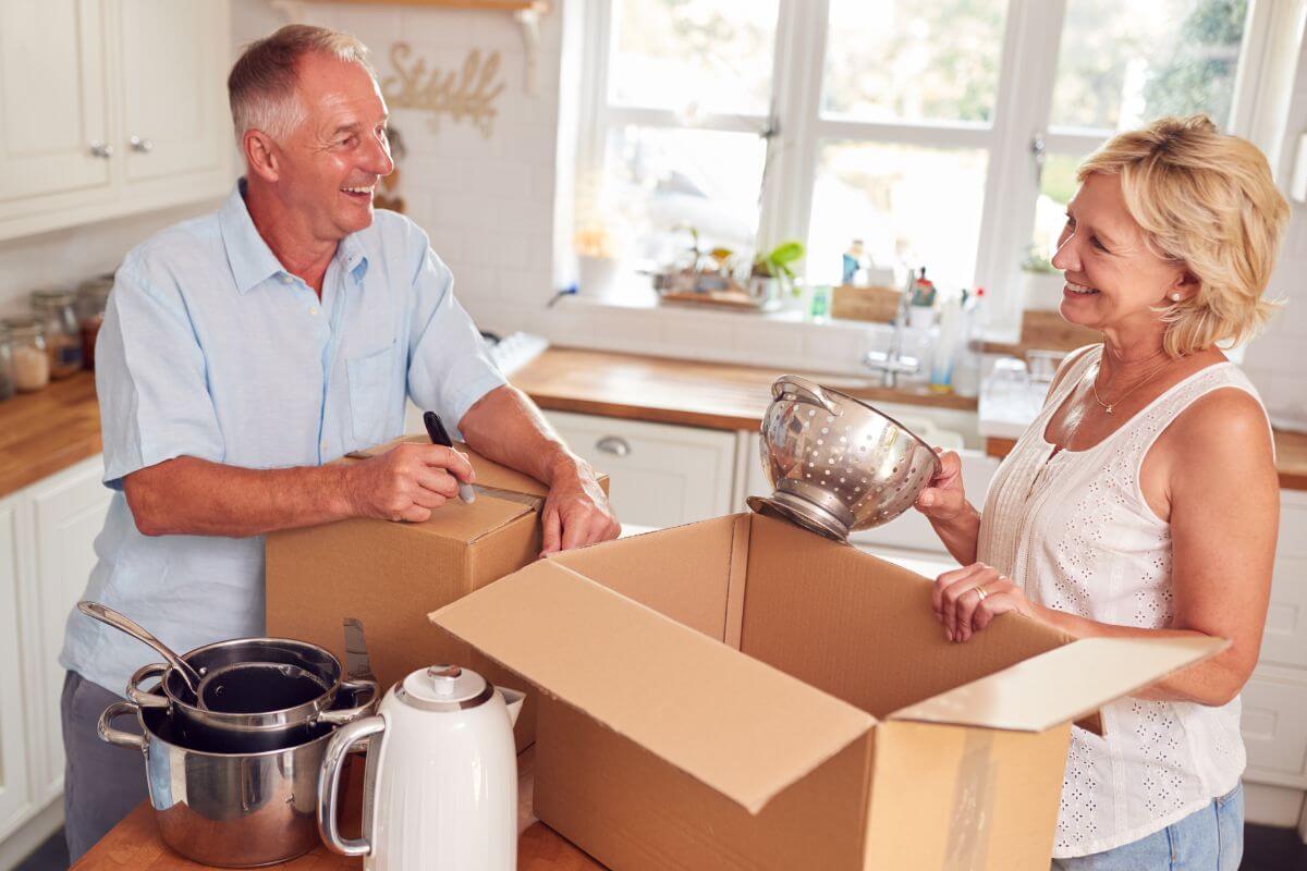 a couple is in the kitchen decluttering and downsizing for seniors.