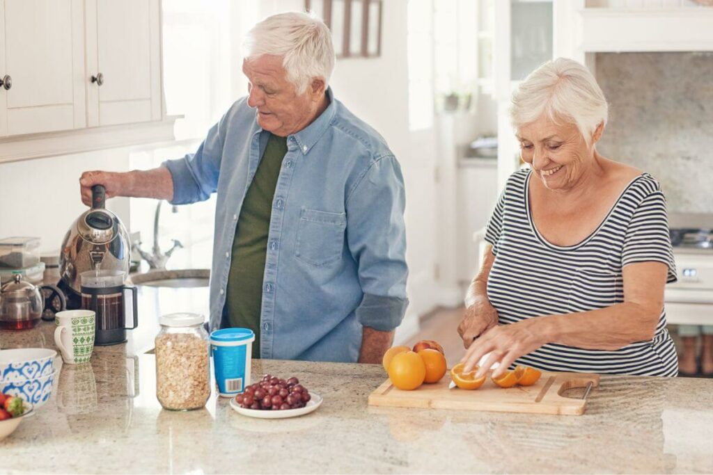 an elderly couple prepares breakfast together after creating an age-inclusive kitchen for safety