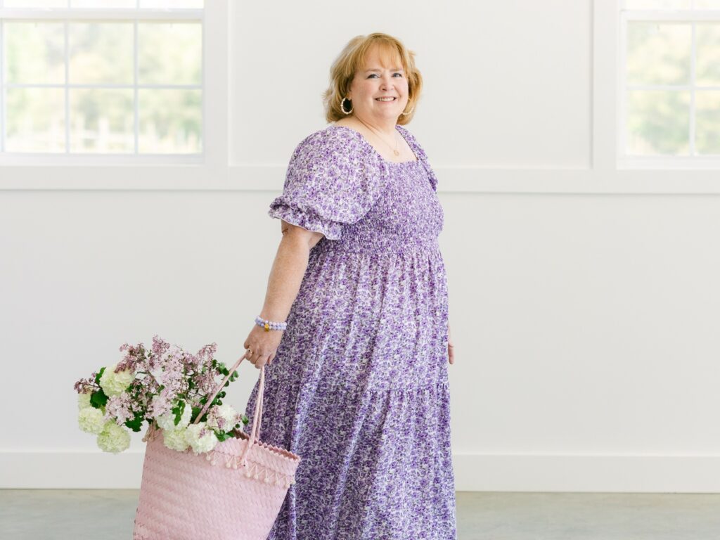 female cheerfully walking with a basket of flowers smiling at the camera - Sassy Sister Stuff Vision and Mission Statement