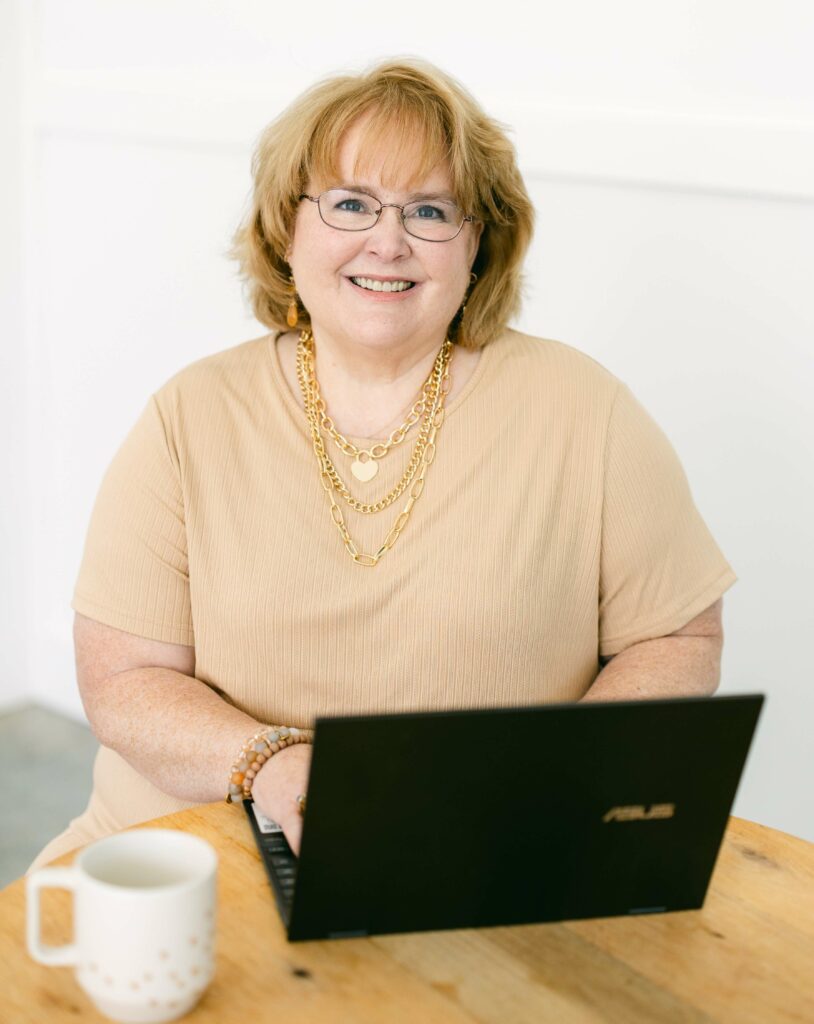 About Photo of woman sitting at computer blogging for her website.