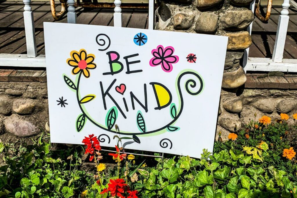 colorful yard sign that says be kind to promote anti-bullying behavior.