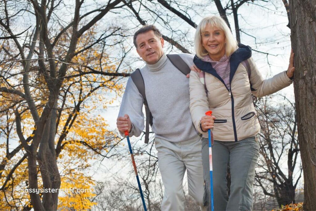 a middle aged wife and husband trek through a park on a fall day to improve their health and happiness.