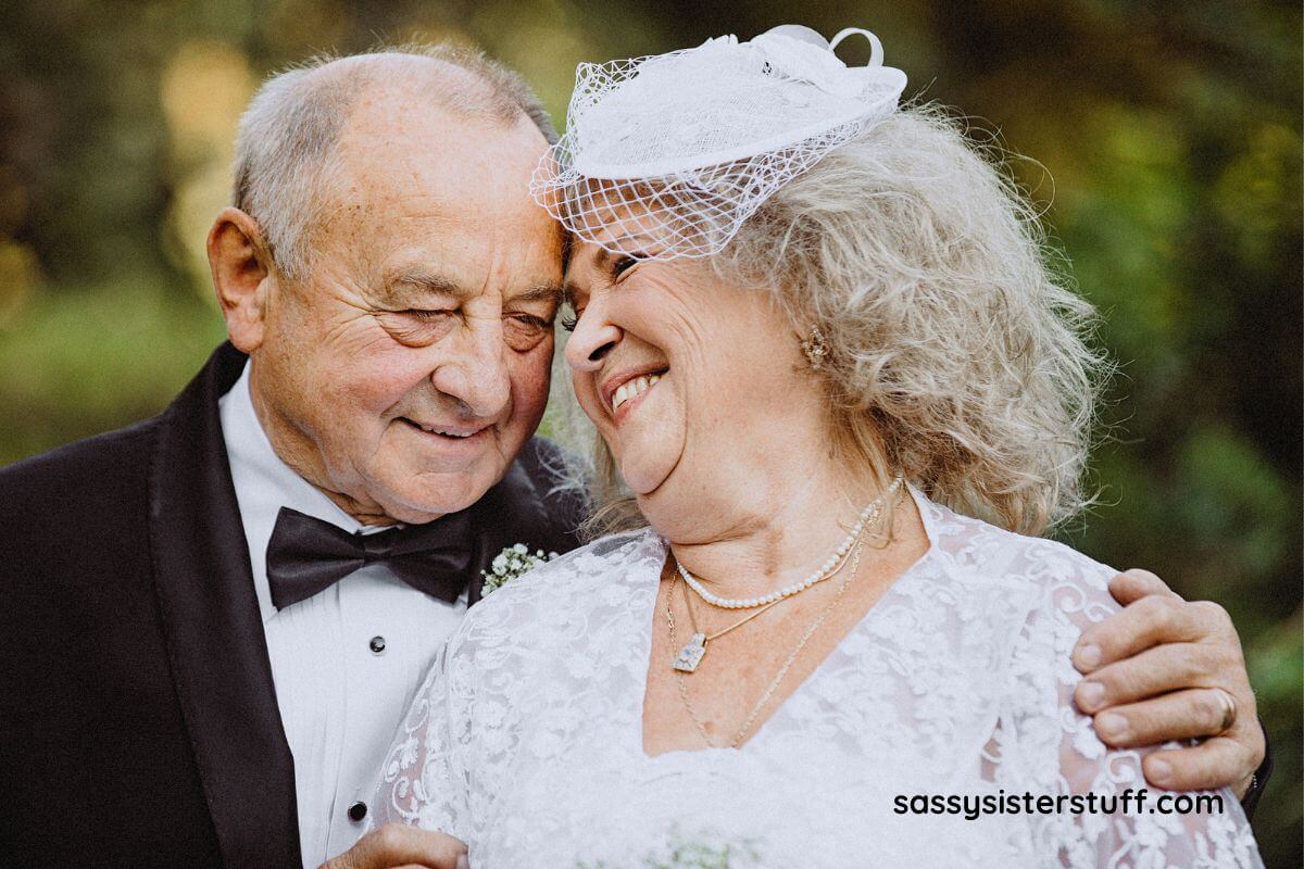 happy elderly couple smiling with their heads together on their wedding day