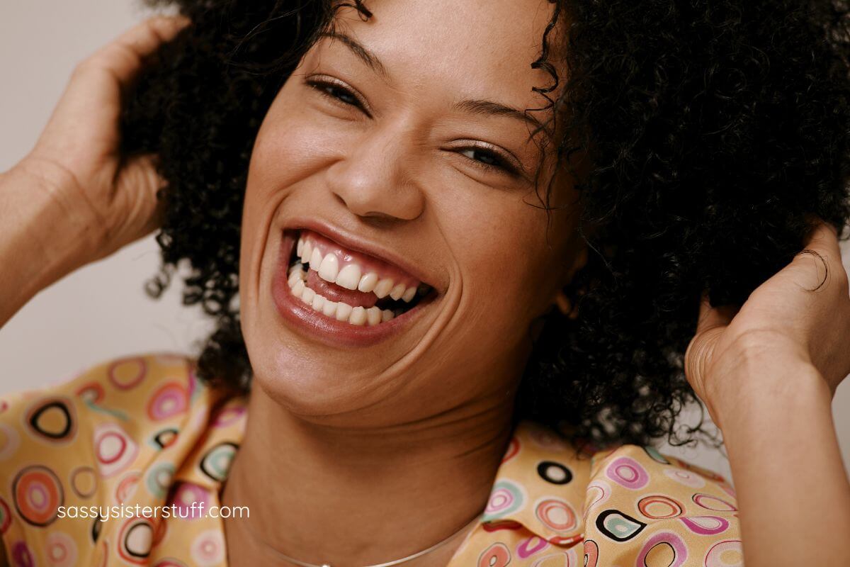 a close-up of beautiful and happy black woman smiling with an abundance of happiness