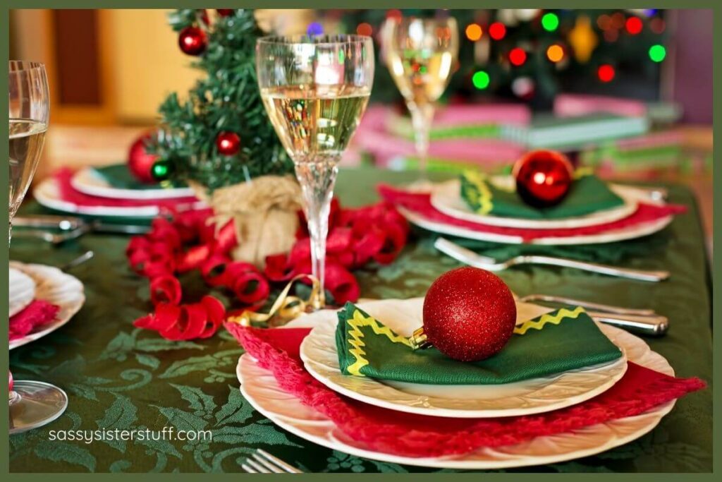 a close-up of a Christmas table setting in green, red, and ivory