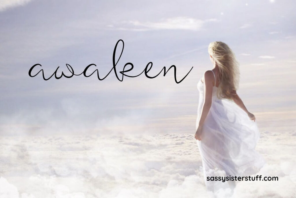 a woman serenely walks across clouds and a text overlay says awaken