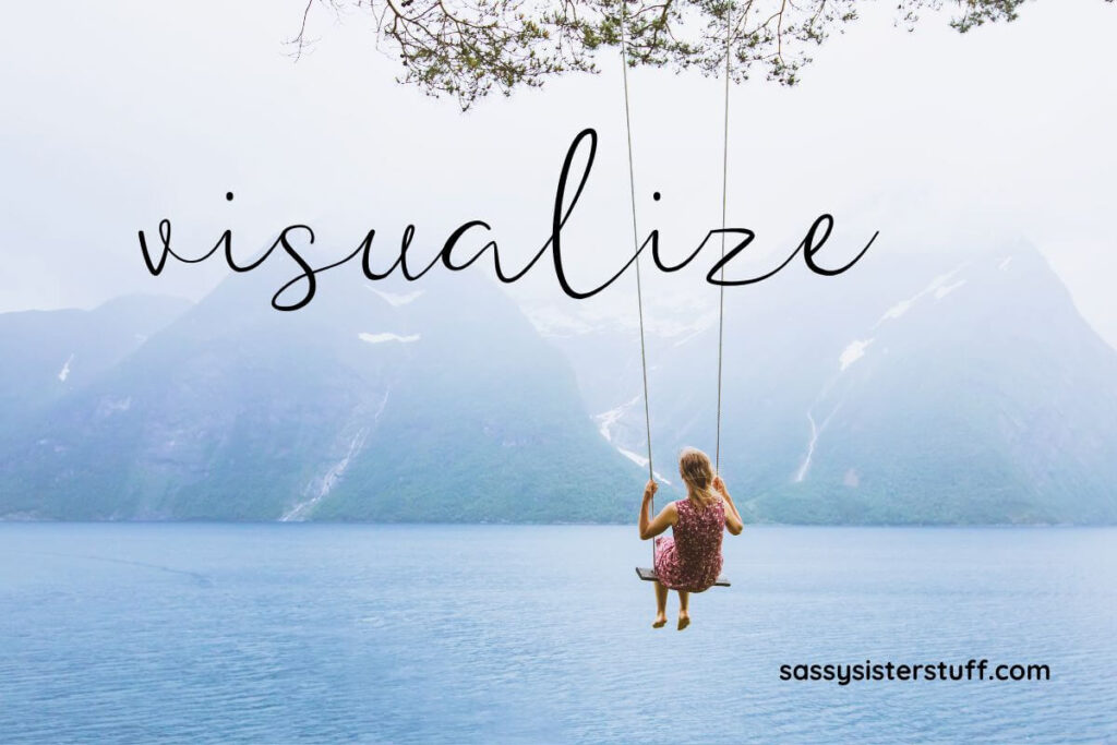 a woman swings on a tree swing over a body of water with mountains in the distance with a text overlay that says visualize