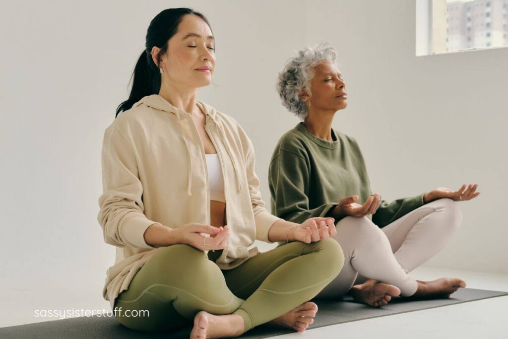 two middle aged ladies do yoga together to practice mindful aging