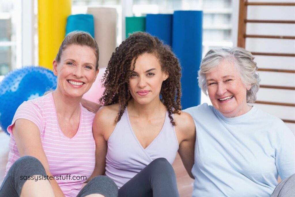 three women enjoy each other's company as they rest after a yoga class