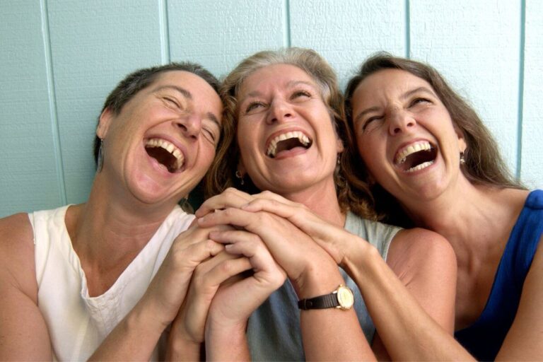 three women laughing hysterically together about life