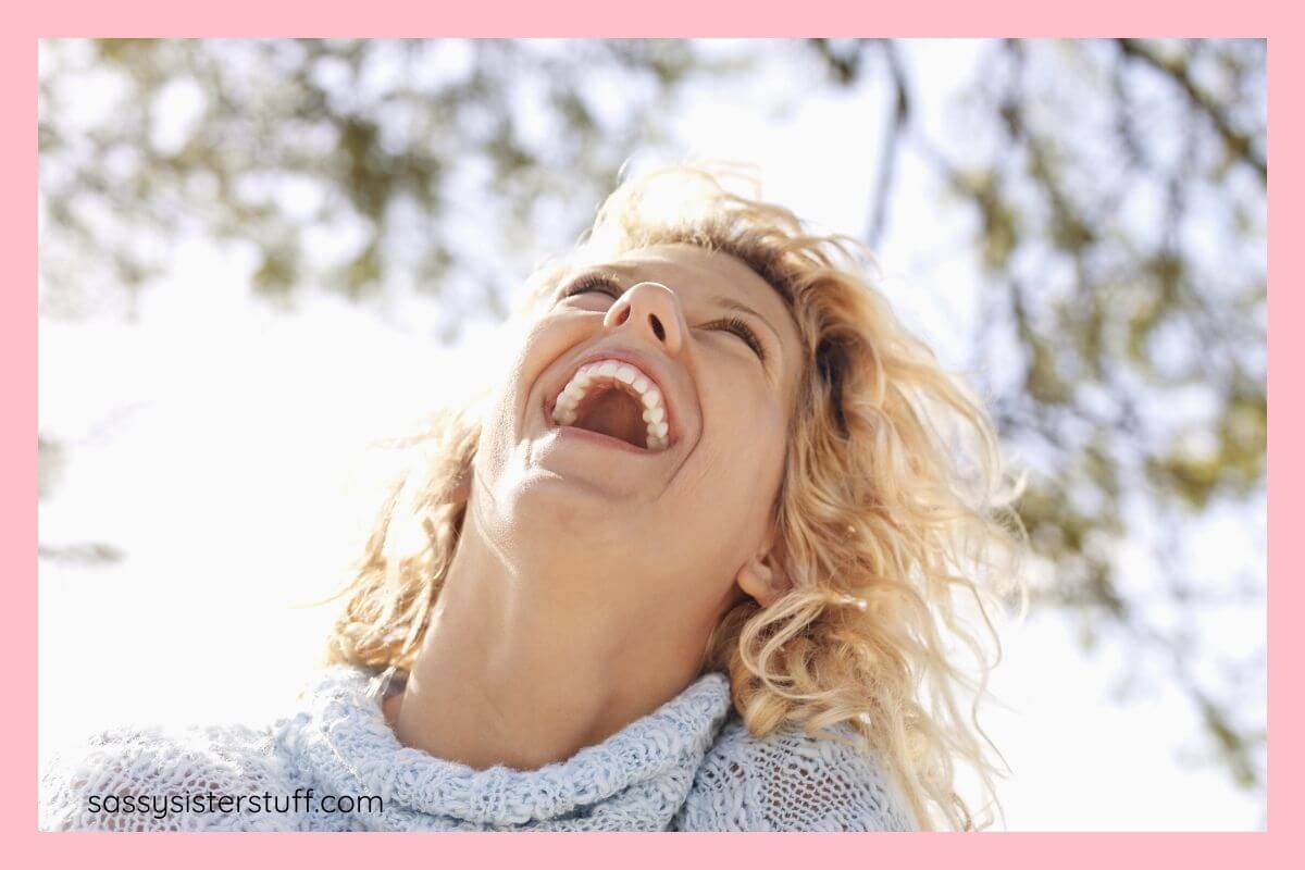 beautifully confident woman laughing out loud; featured image for funny self love quotes