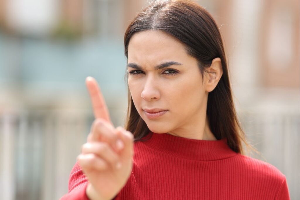 A woman wearing red pointing her finger