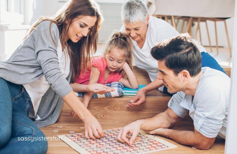 three generations of family members play a board game together