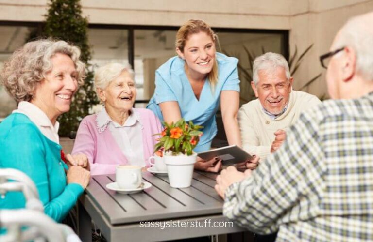 a group of seniors enjoy a conversation together while they have coffee