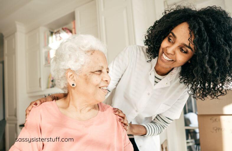 a senior citizen and her assistant happily chat together