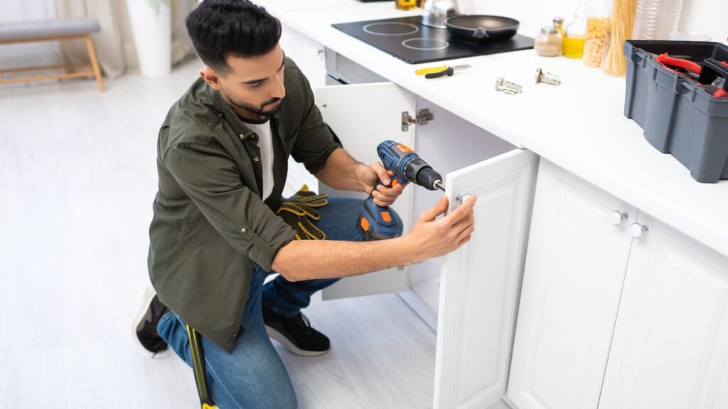 DIY man fixing cabinet