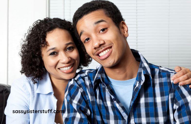 a mom and son smile for a photo before he goes off to live in the city, leaving her in an empty nest.