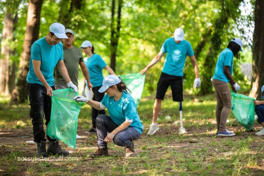 a midlife couple volunteers with others to pick up trash in a park.