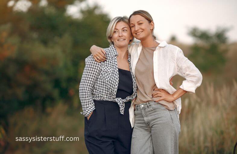 middle aged mom and adult daughter hug each other as they figure out their new relationship.