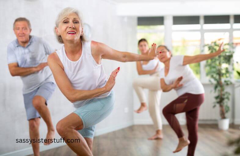 middle aged group of people enjoy an exercise class together.