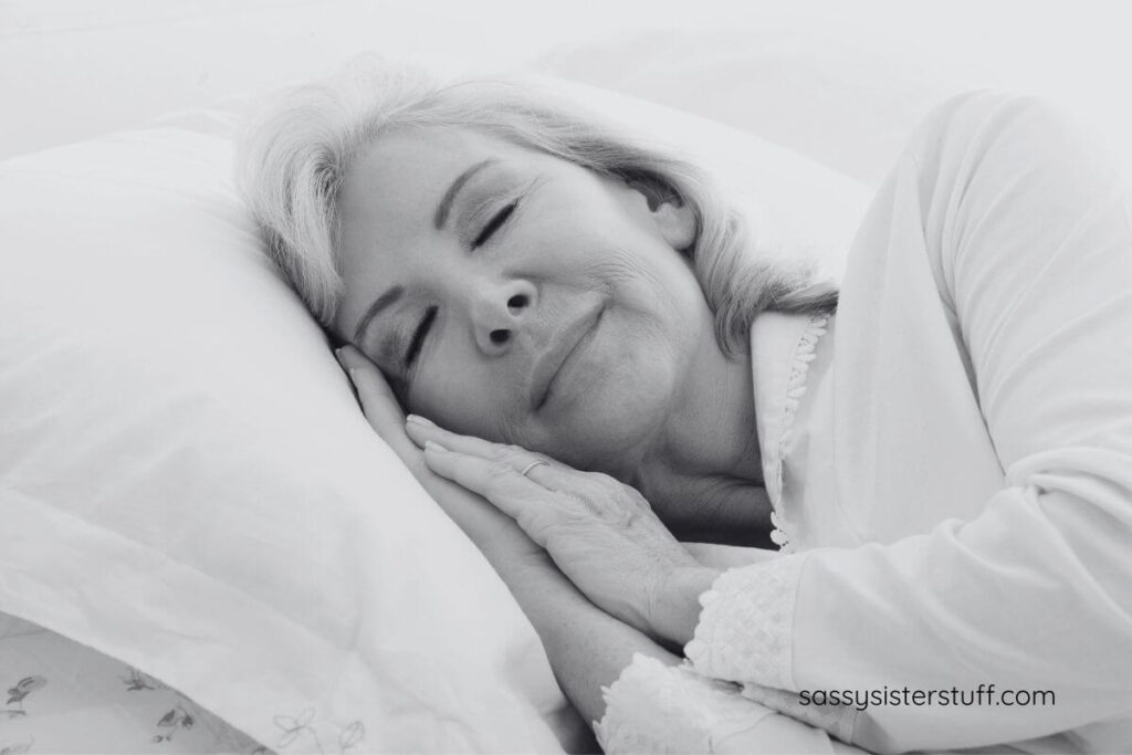 middle aged woman sleeping comfortably in warm pajamas.