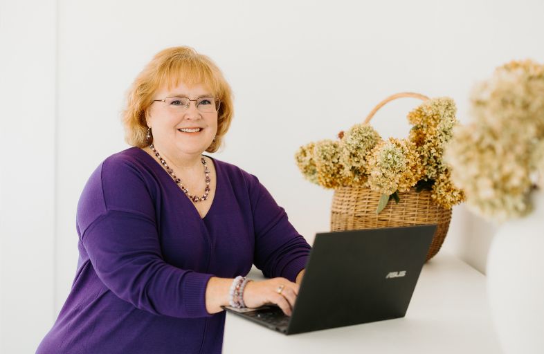 female writer typing on laptop