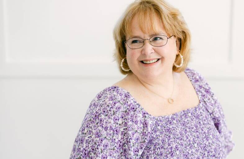 close up of a smiling middle age female looking over her shoulder