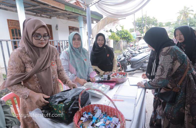 travelers visit a village in Inda and learn about crafting from the village women