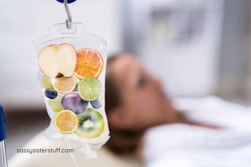 vitamin IV drip with apples, lemons, oranges and berries in the IV bag.