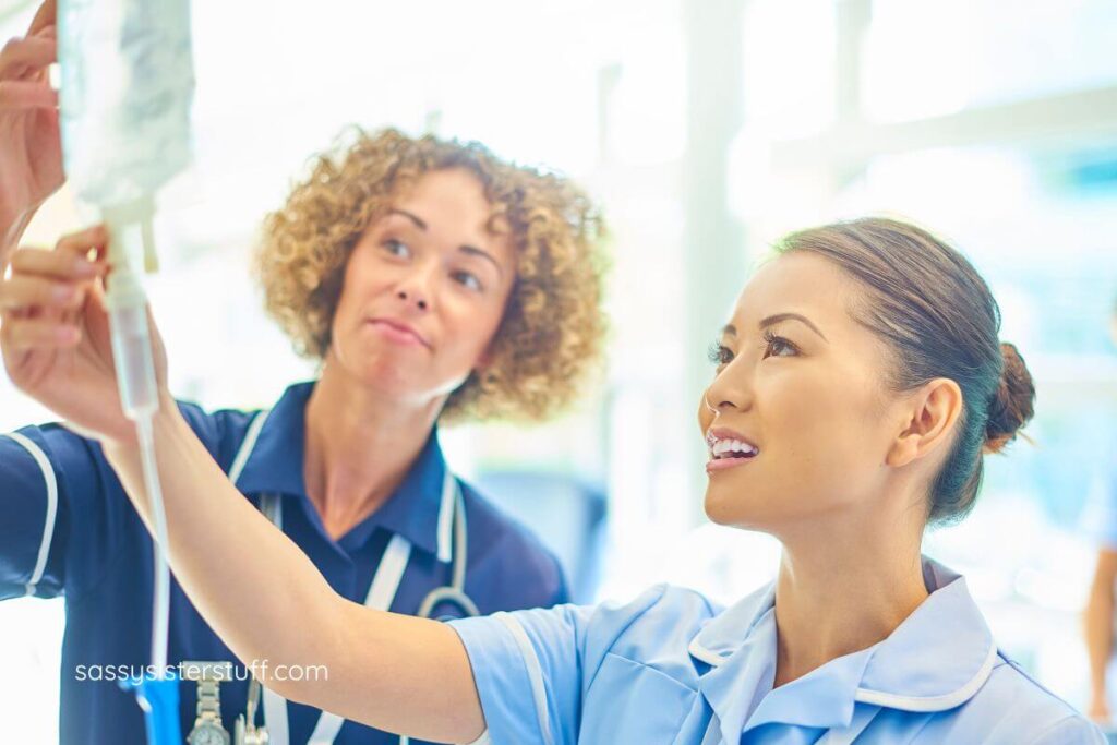 two trained nurses check an IV bag.