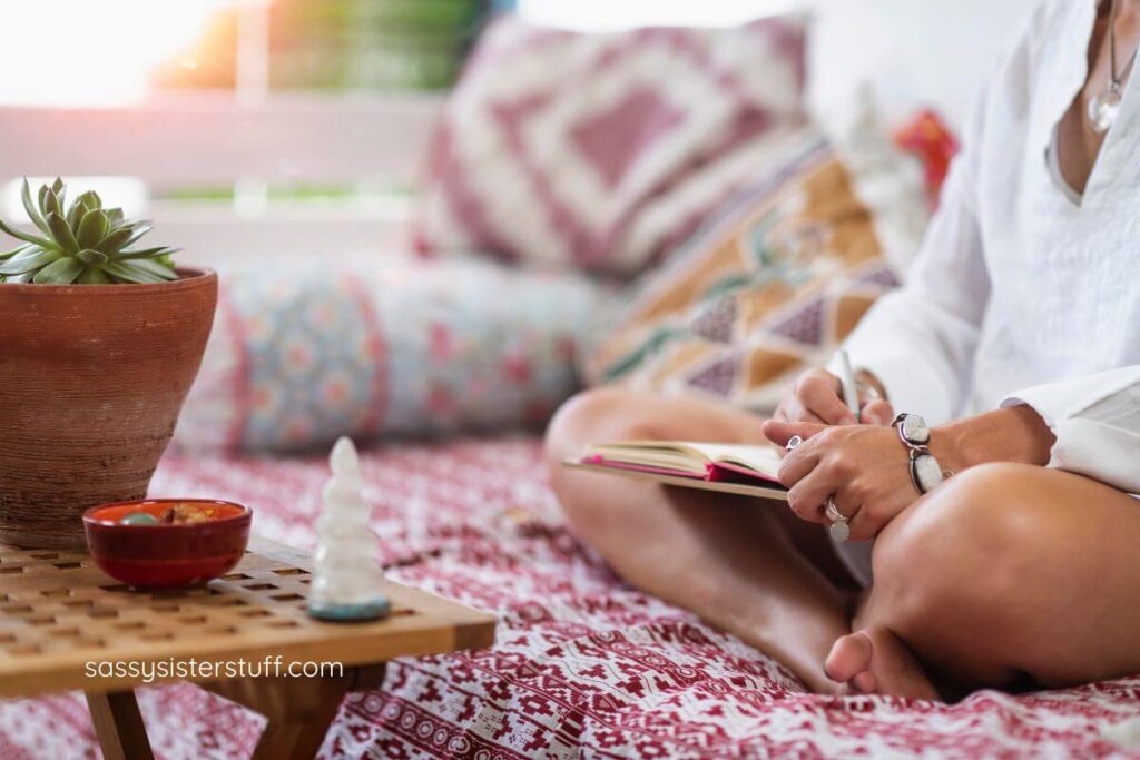 close up of female writing in her journal for personal growth.