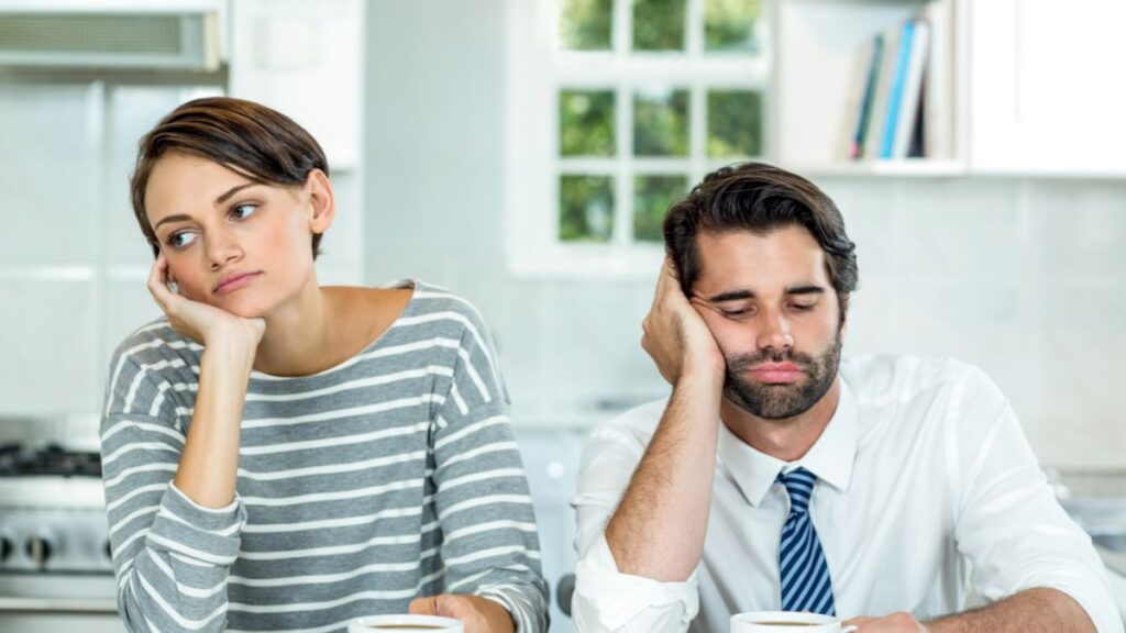 bored couple sitting at table