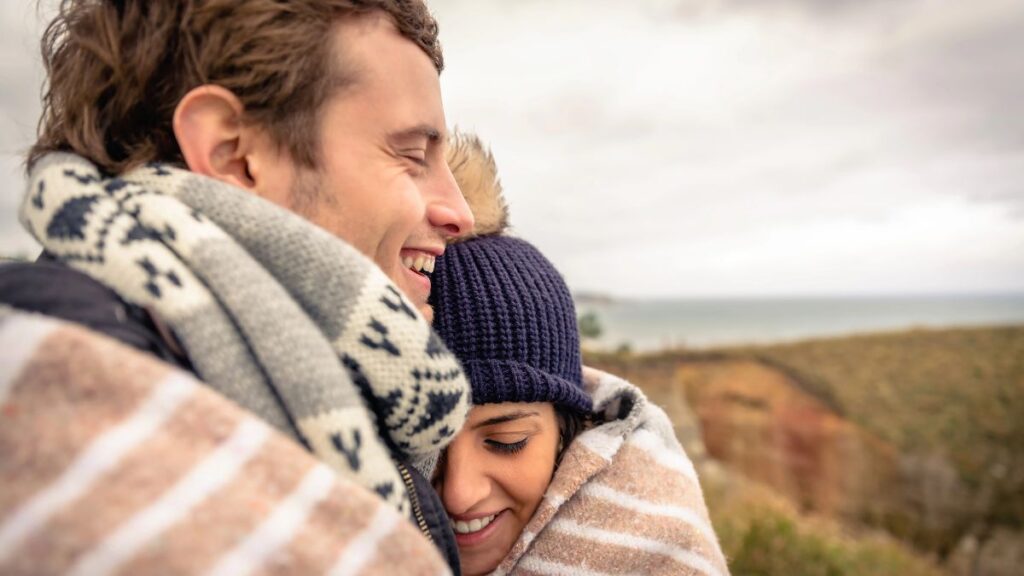 couple hugging in blanket outside