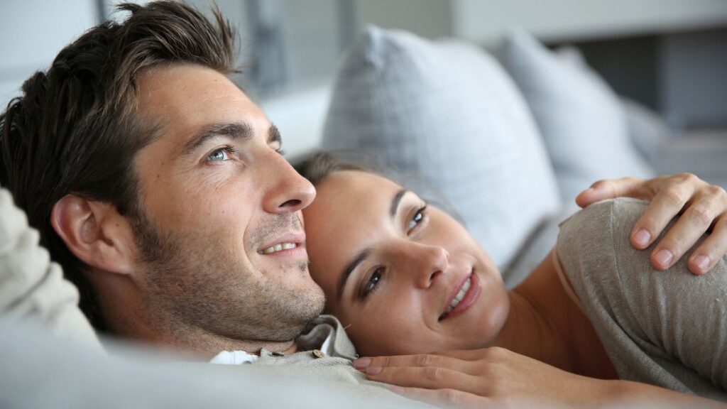 couple laying on bed together