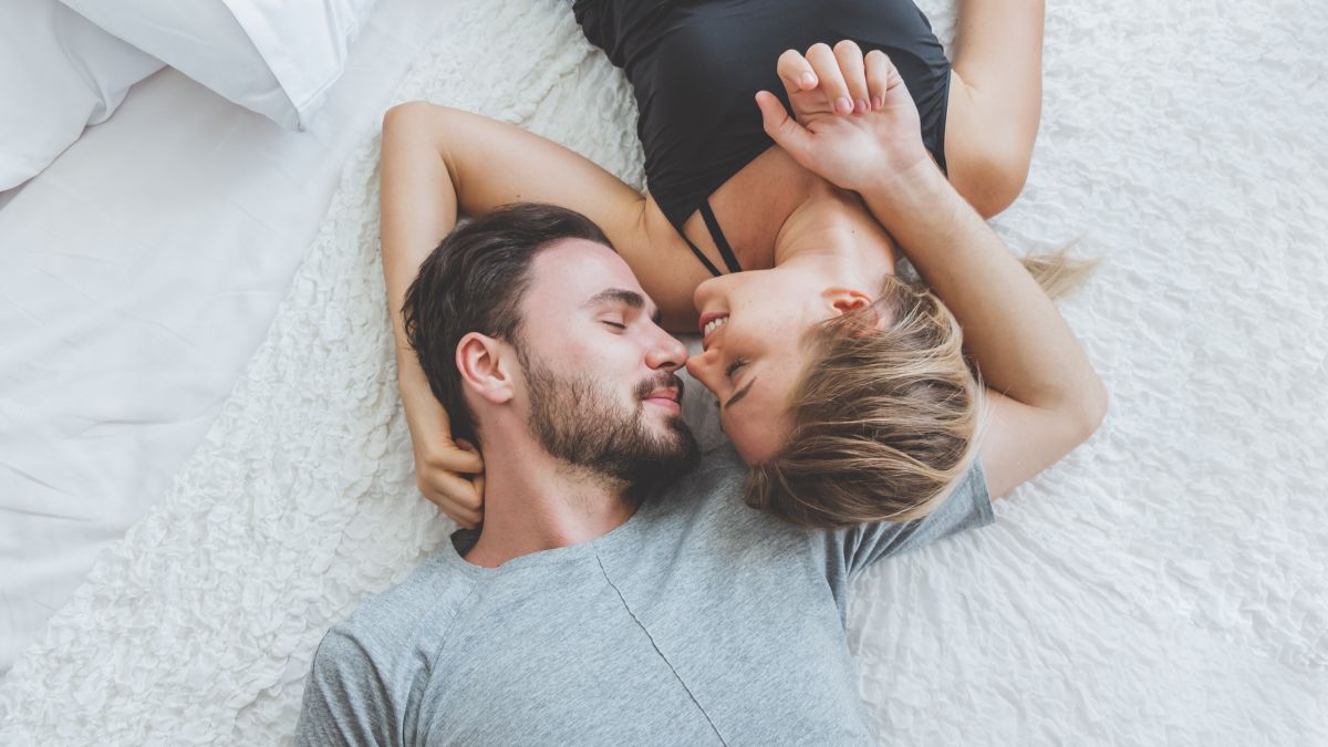 couple laying with faces together