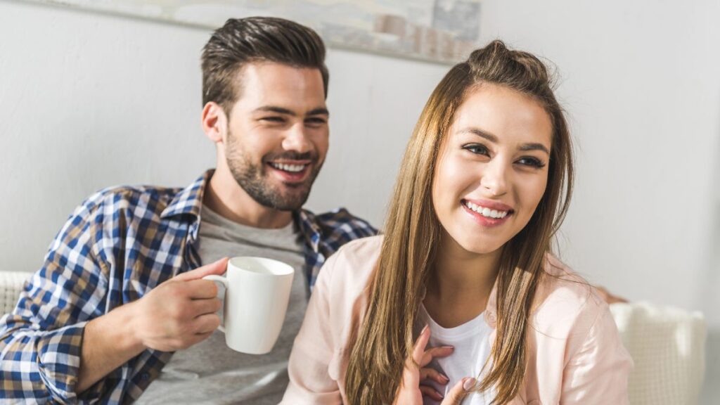 couple sitting on couch with coffee