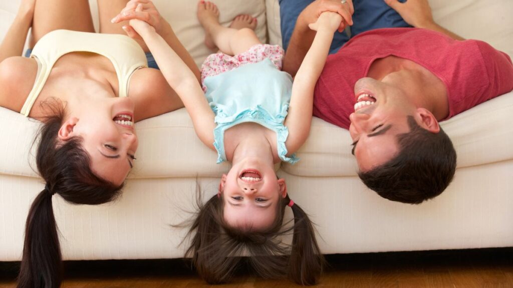 family laying on couch