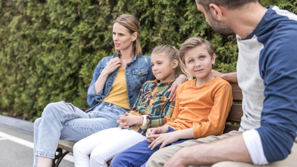 family talking on bench