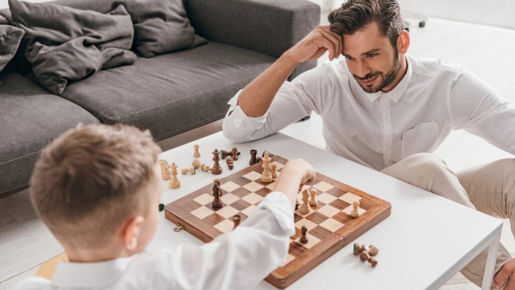 father and son playing chess